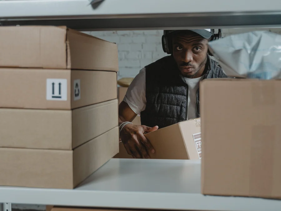 Worker organizing stock on warehouse shelves