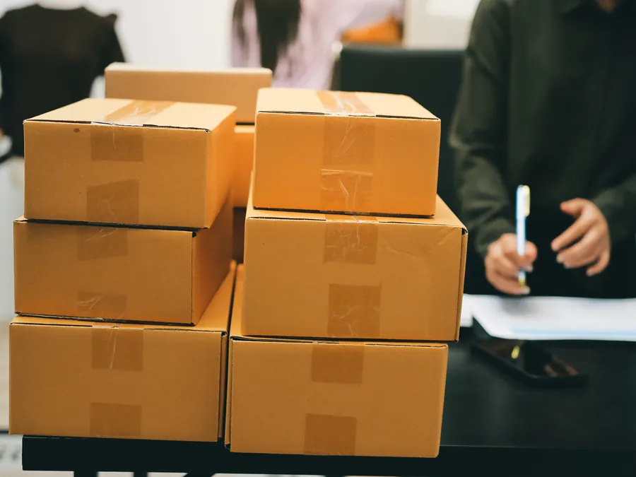 Stacked cartons ready for shipping while paperwork is signed