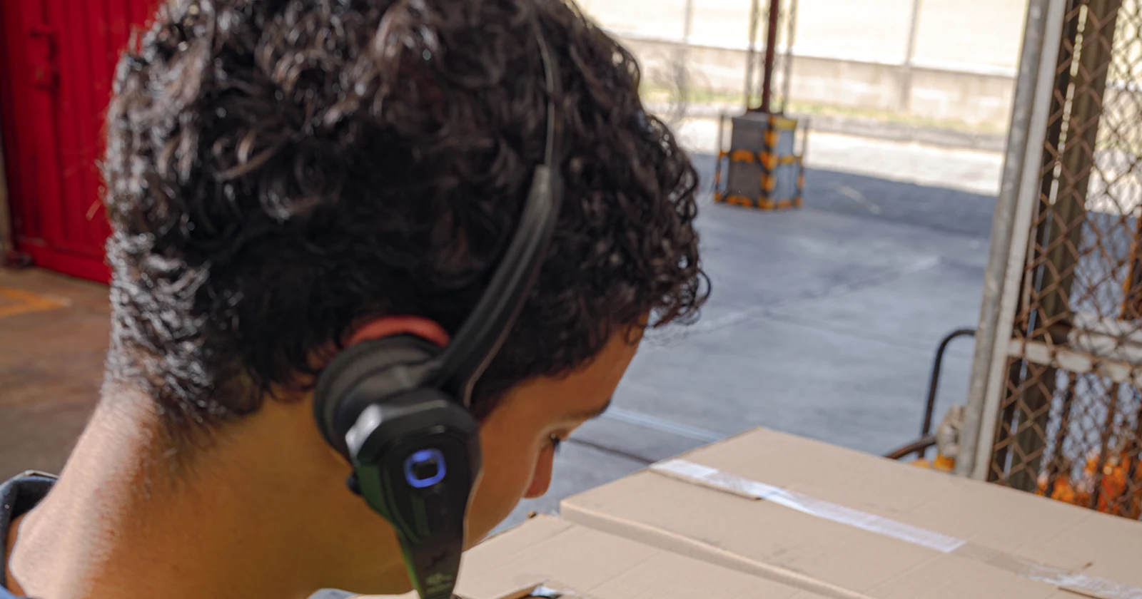 Zebra headset and wearable computer used by a warehouse worker at a carton