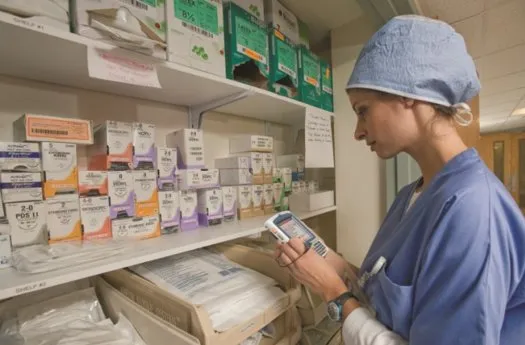 Nurse scanning medicine in a hospital store room